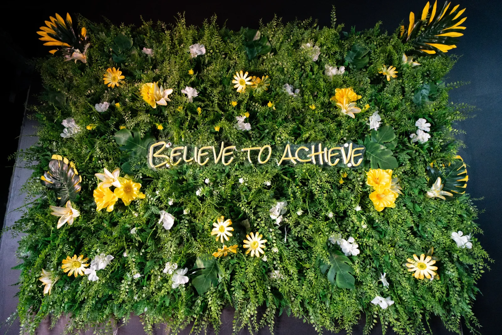 Believe to Achieve flower wall at HQ Brew